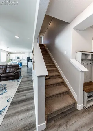 a view of a hallway with a livingroom and furniture