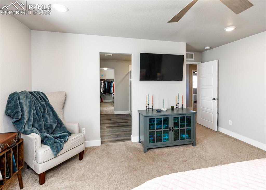 12653 Granite Ridge Drive Peyton, CO 80831 - Photo 33 of 50 a living room with furniture and a flat screen tv