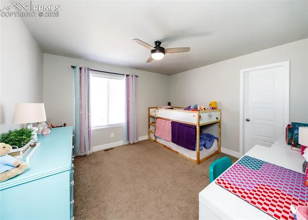 a living room with lots of furniture and a lamp