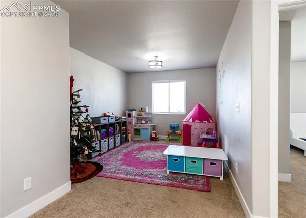 a view of a hallway to a livingroom with furniture