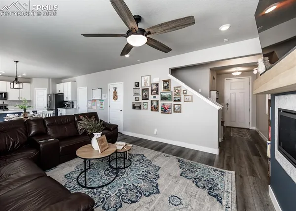 a living room with furniture a fireplace and a flat screen tv