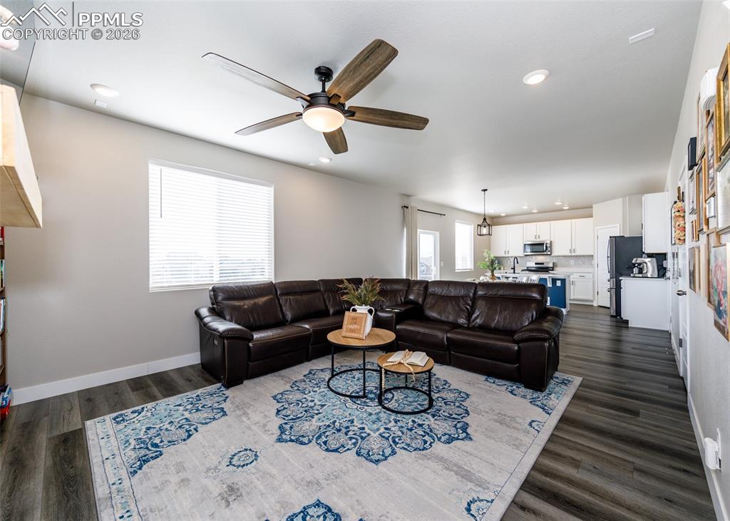 12653 Granite Ridge Drive Peyton, CO 80831 - Photo 9 of 50 a living room with furniture and a wooden floor