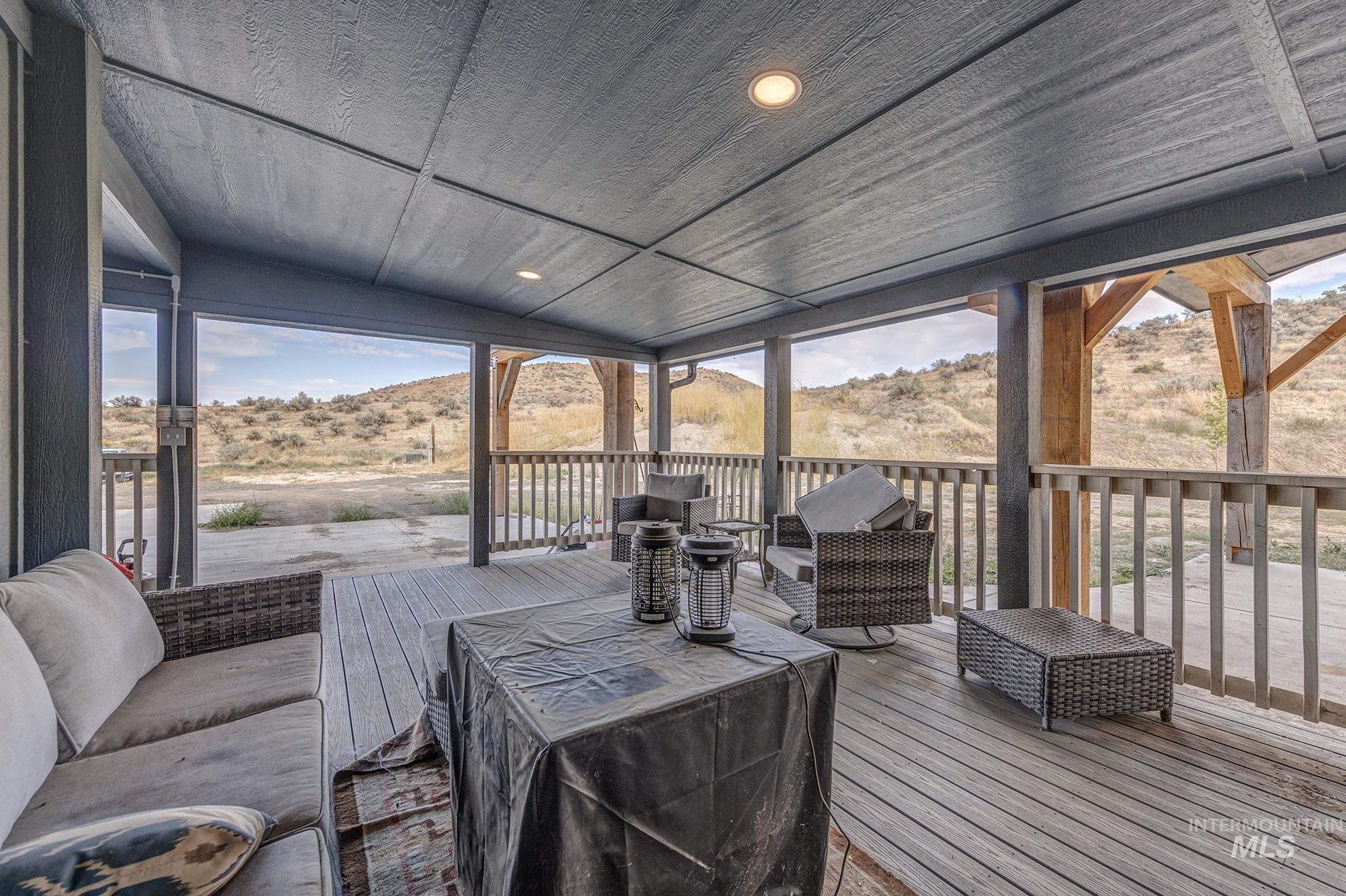 1587 Gentry Lane Weiser, ID 83672 - Photo 31 of 41 Wooden deck featuring a mountain view and an outdoor hangout area