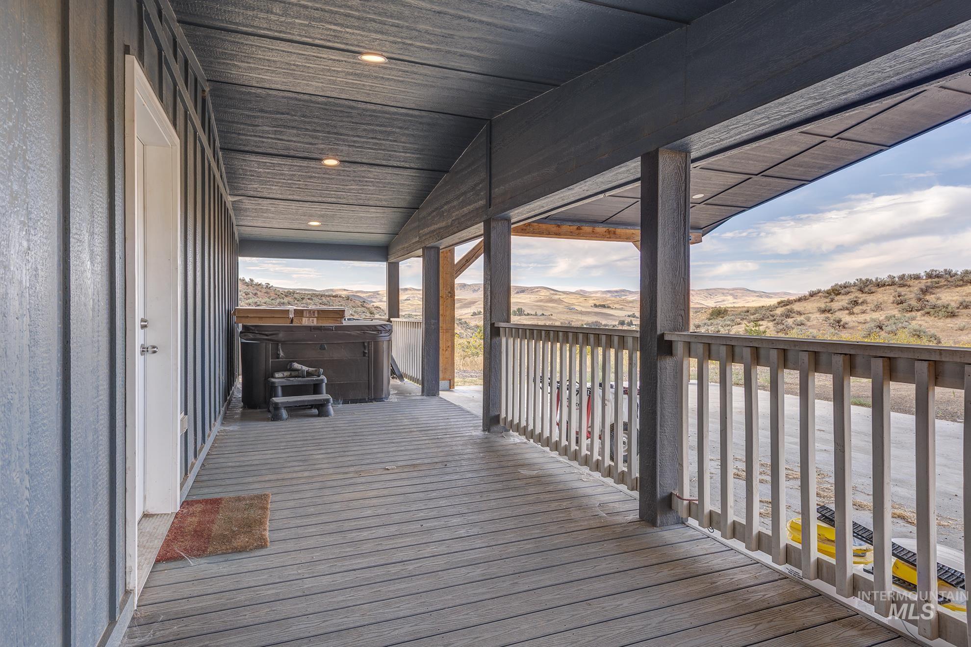 1587 Gentry Lane Weiser, ID 83672 - Photo 32 of 41 Wooden deck featuring a hot tub and a mountain view