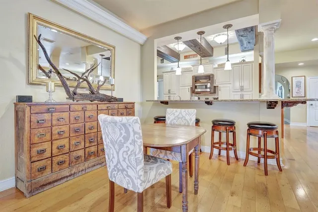 a dining room with furniture and wooden floor