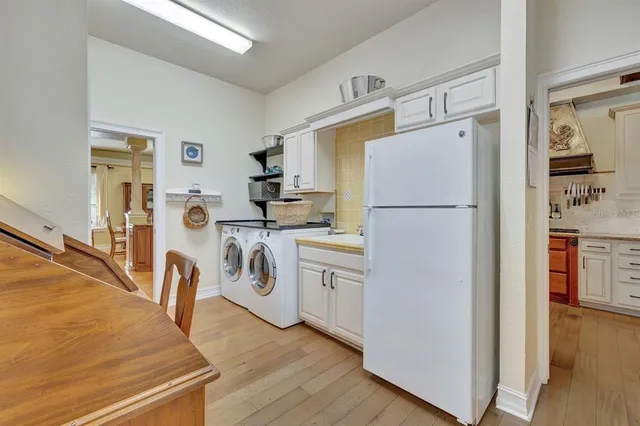 a utility room with sink dryer and washer