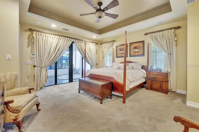 a bedroom with a bed and a chandelier