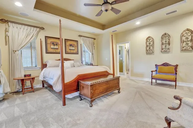 a spacious bedroom with a bed and a flat screen tv