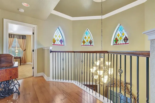 a spacious bedroom with a bed and a chandelier