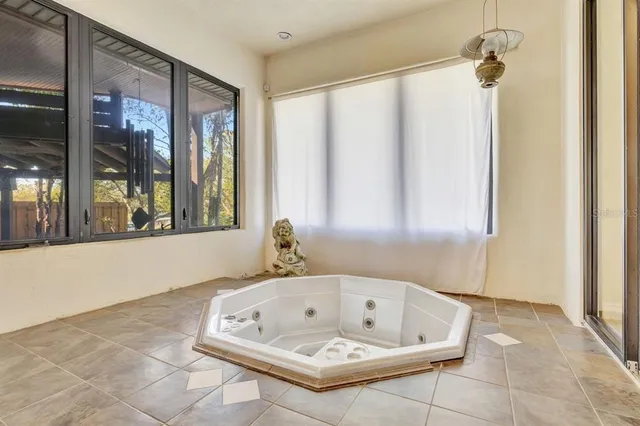 a view of a dining room with furniture large windows and wooden floor