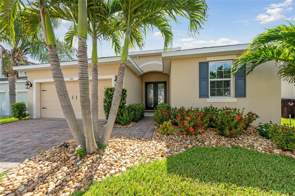 a front view of a house with garden