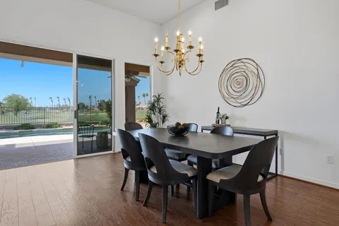 a view of a dining room with furniture wooden floor and a chandelier