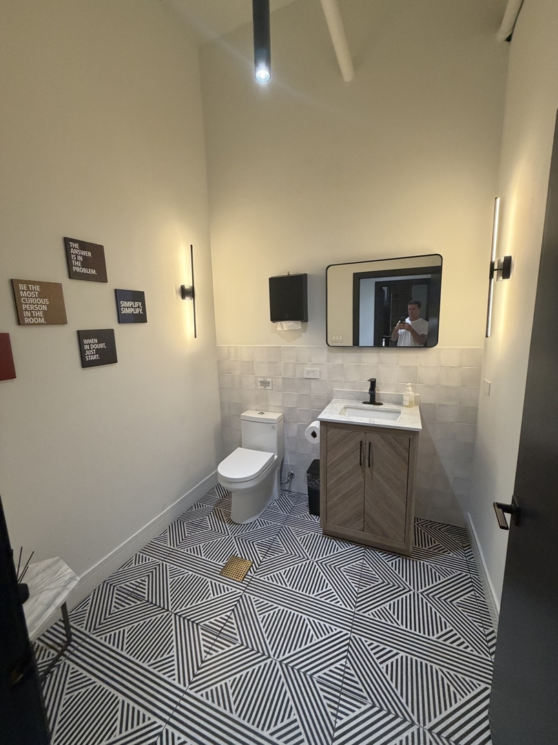 727 South Dearborn Street, Unit 211 Chicago, IL 60605 - Photo 29 of 34 a bathroom with a sink a toilet and mirror