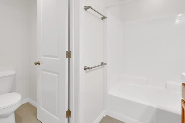 a bathroom with a shower and a toilet