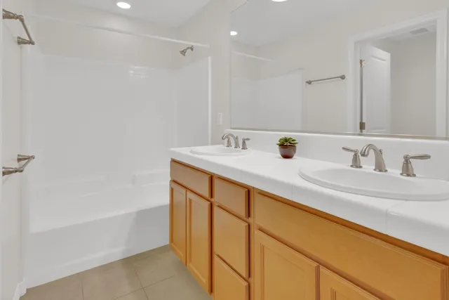 a bathroom with a sink double vanity and a bathtub