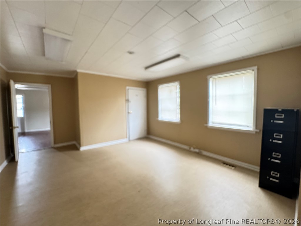 202 Main Street Hamlet, NC 28345 - Photo 5 of 7 a view of an empty room with a window