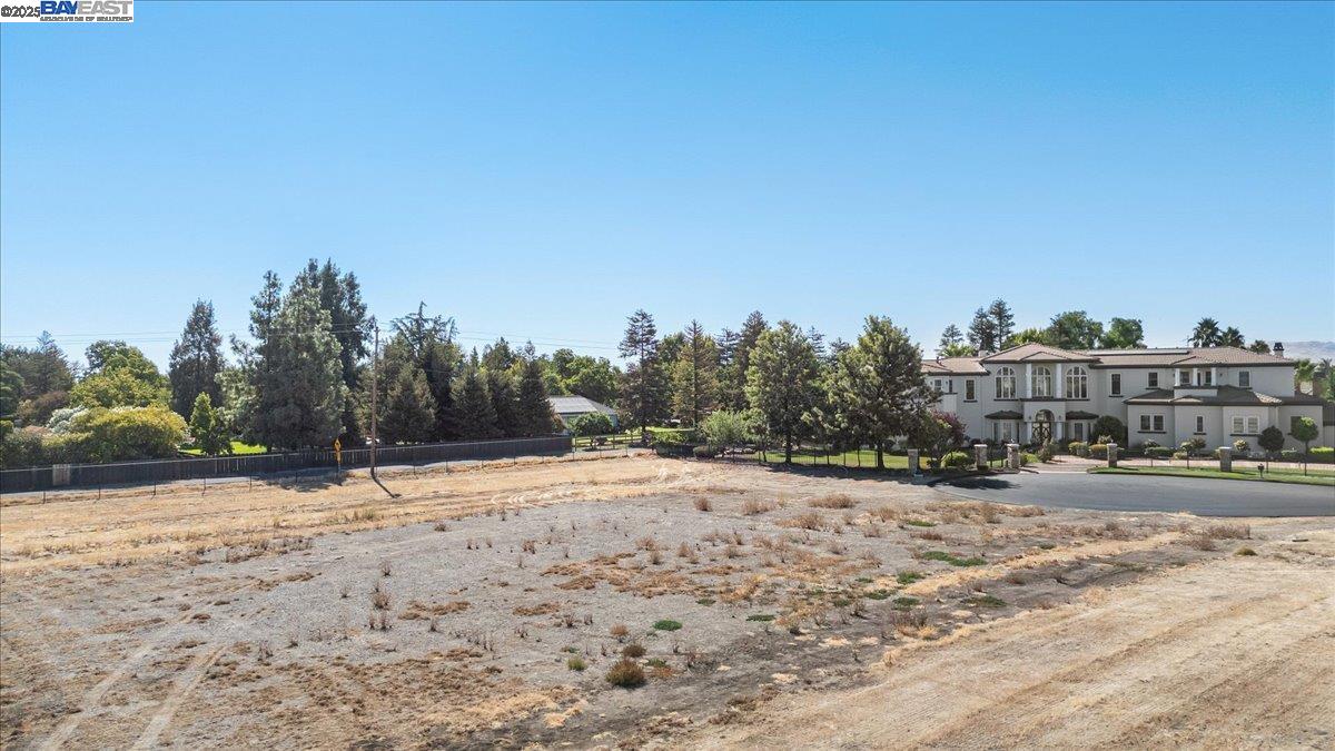 8485 West Ranch Road Tracy, CA 95304 - Photo 6 of 20 a view of dirt yard with a building and trees in the background