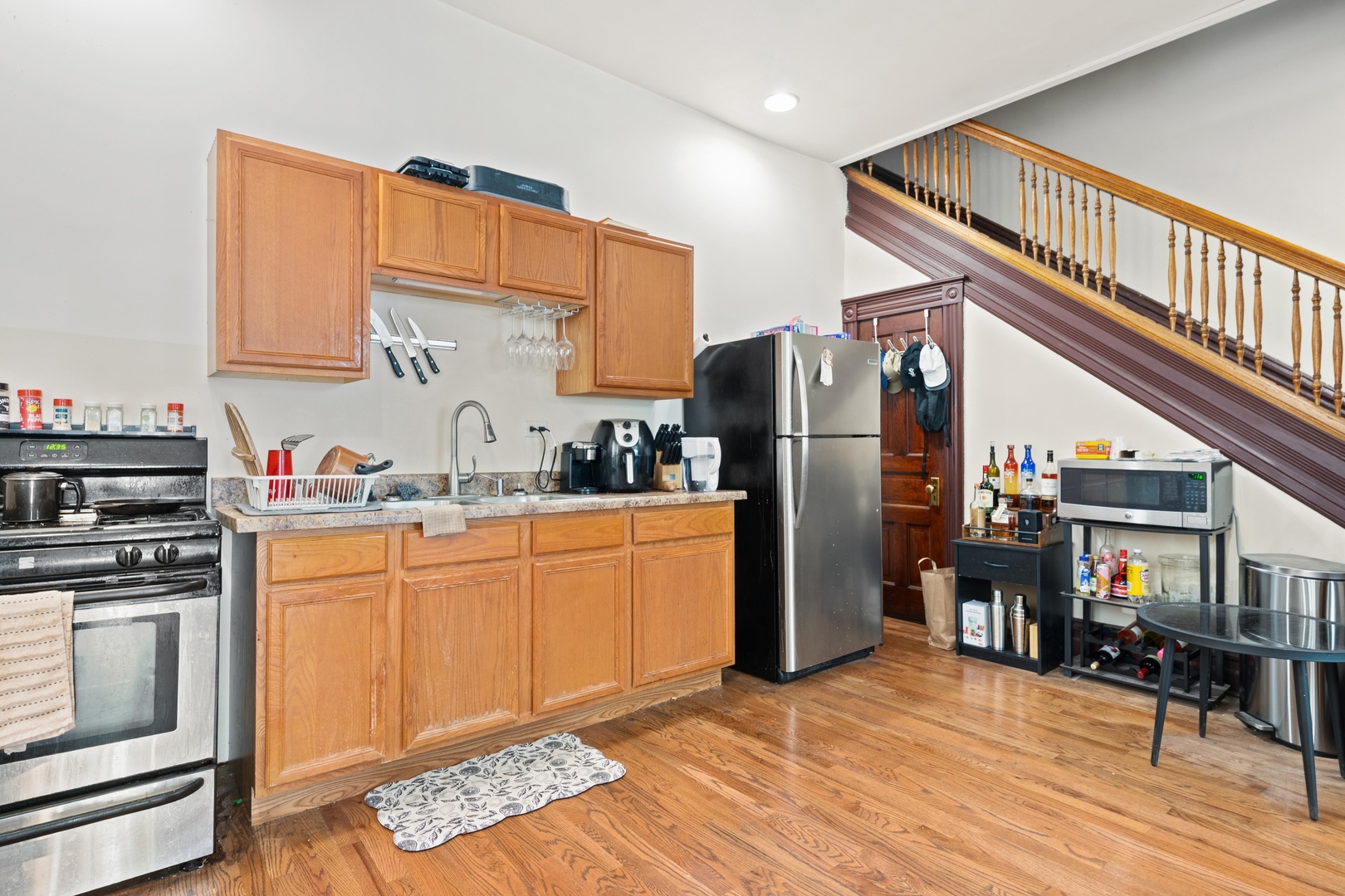 1132 East 44th Street Chicago, IL 60653 - Photo 7 of 23 a kitchen with stainless steel appliances granite countertop a refrigerator a stove and a sink with cabinets