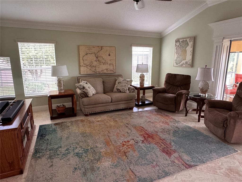 2005 Markridge Loop The Villages, FL 32162 - Photo 11 of 36 a living room with furniture and a flat screen tv