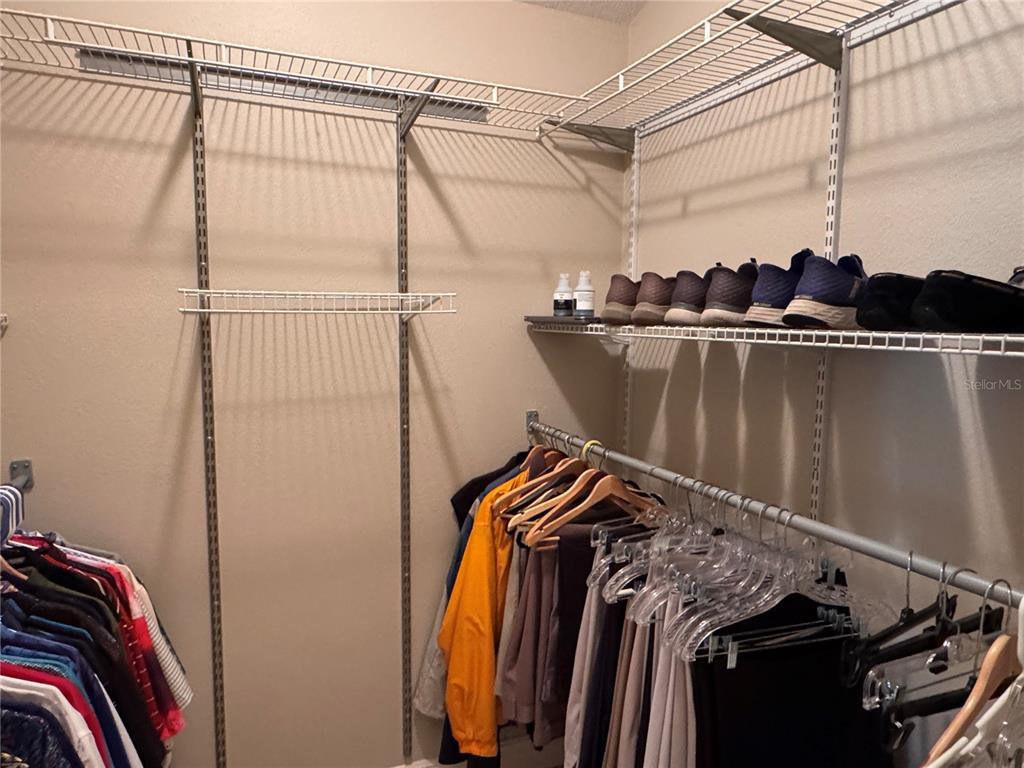 2005 Markridge Loop The Villages, FL 32162 - Photo 21 of 36 a view of walk in closet with clothes and shoes