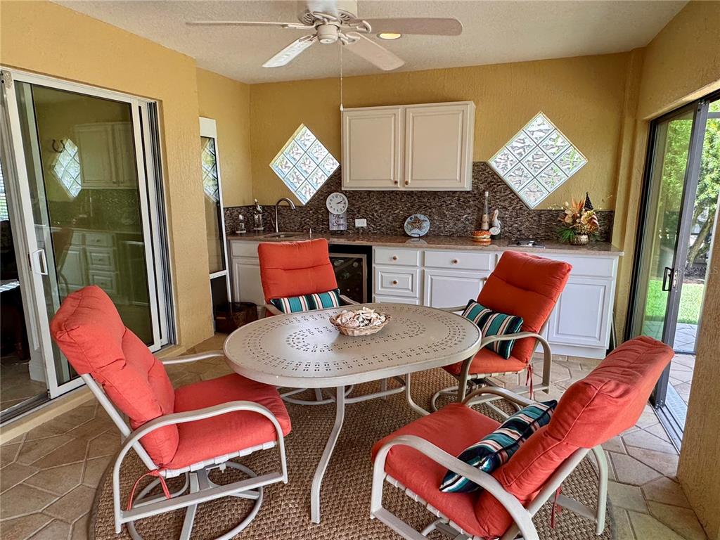 2005 Markridge Loop The Villages, FL 32162 - Photo 26 of 36 a outdoor dining room with furniture and wooden floor