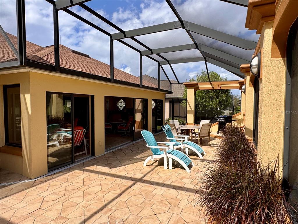 2005 Markridge Loop The Villages, FL 32162 - Photo 30 of 36 a patio with yard glass top table and chairs