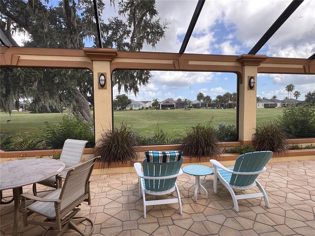 2005 Markridge Loop The Villages, FL 32162 - Photo 34 of 36 a view of a patio with a dining table and chairs