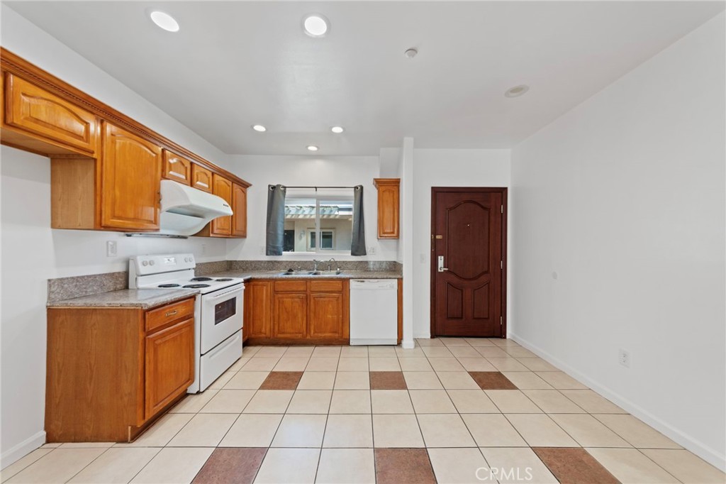 421 South Garfield Avenue, Unit 79 Monterey Park, CA 91754 - Photo 4 of 23 a kitchen with stainless steel appliances granite countertop a refrigerator and a stove top oven