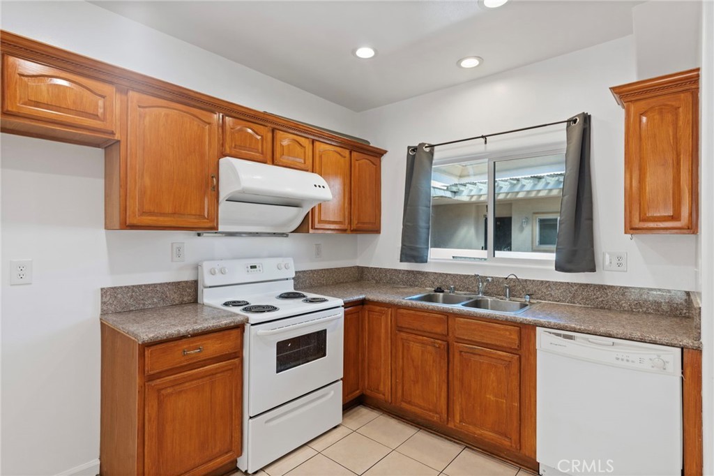 421 South Garfield Avenue, Unit 79 Monterey Park, CA 91754 - Photo 5 of 23 a kitchen with granite countertop cabinets stainless steel appliances a sink and a window