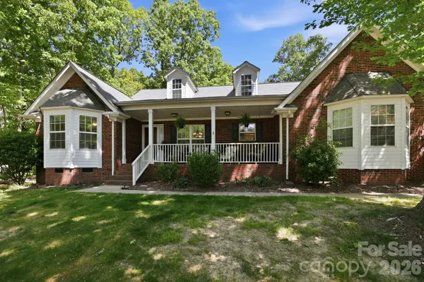 a view of a house with a yard and plants
