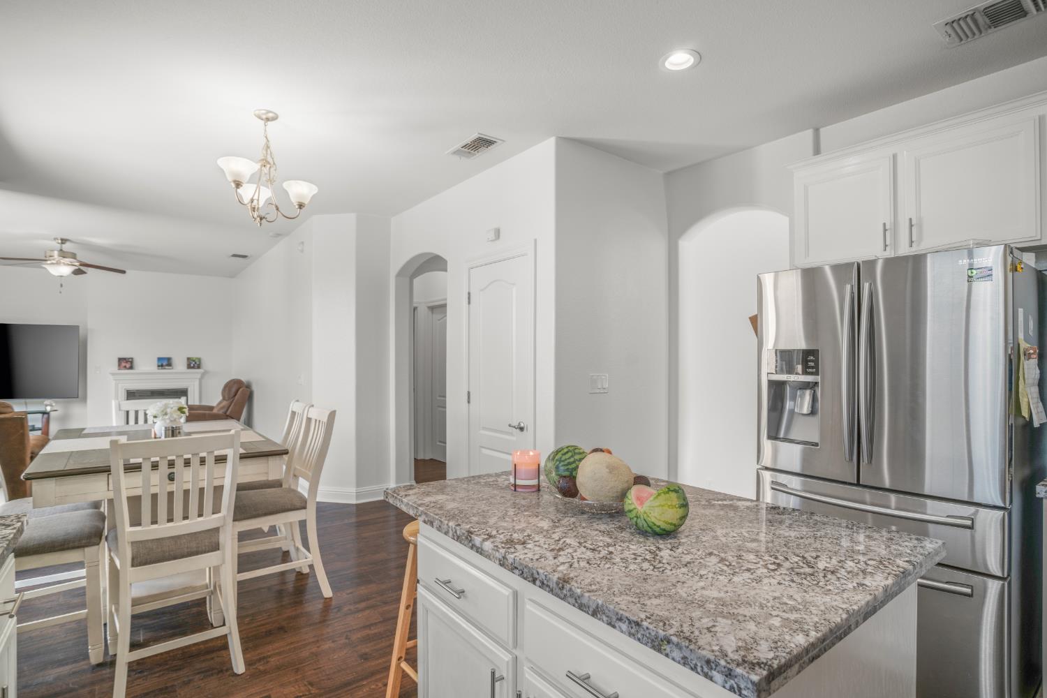 3815 Lee Brook Way Sacramento, CA 95838 - Photo 11 of 43 a kitchen with stainless steel appliances granite countertop a table chairs stove and refrigerator