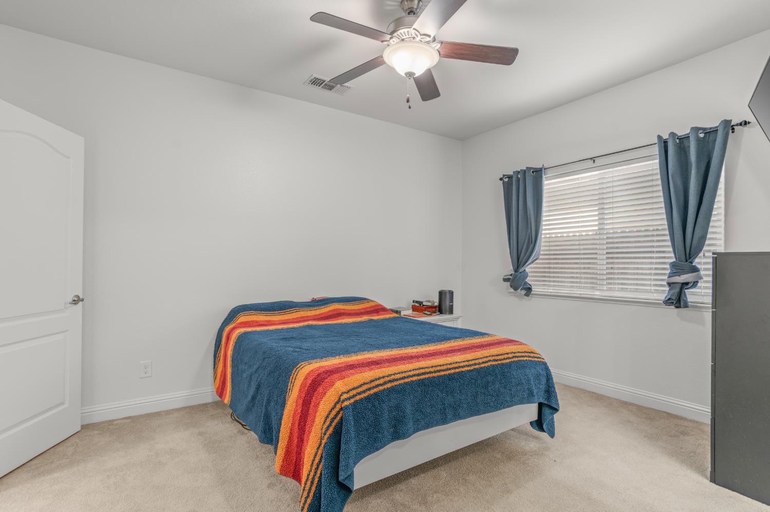 3815 Lee Brook Way Sacramento, CA 95838 - Photo 19 of 43 a bedroom with a bed and a chandelier