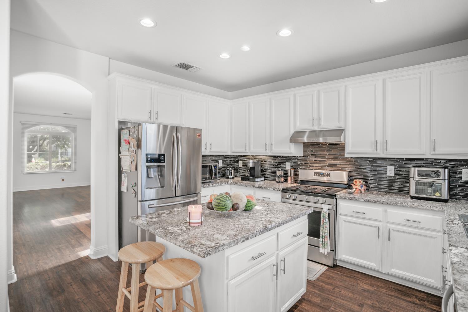 3815 Lee Brook Way Sacramento, CA 95838 - Photo 10 of 43 a kitchen with kitchen island granite countertop a stove sink and refrigerator