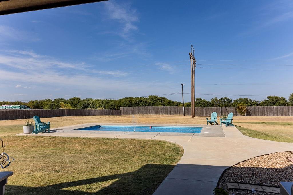 123 Cactus Drive Decatur, TX 76234 - Photo 21 of 30 In-ground swimming pool with a concrete surround, privacy fencing, and a concrete pathway