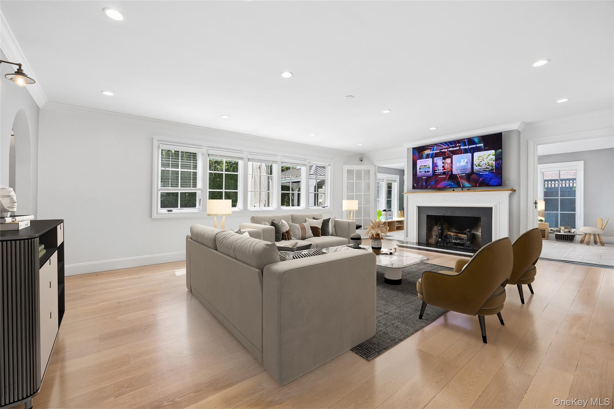 216 Beverly Road Queens, NY 11363 - Photo 1 of 50 a living room with furniture a fireplace and a large window