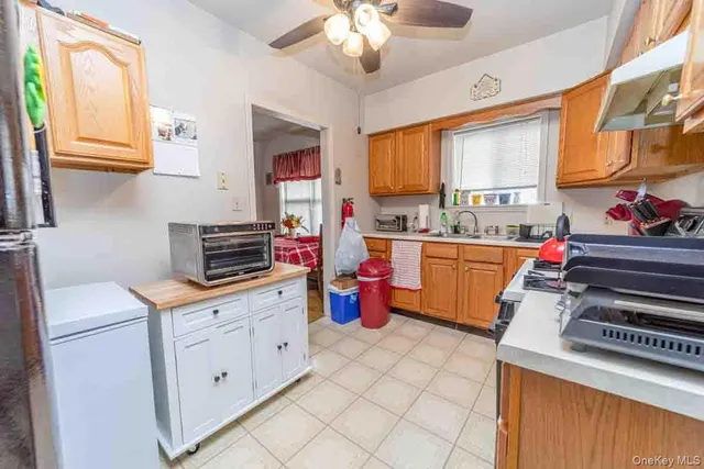 a kitchen with a stove a sink and a refrigerator