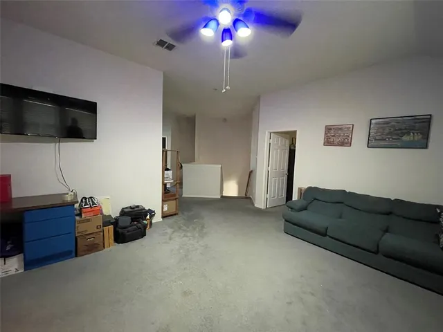 a view of a workspace with furniture and a flat screen tv