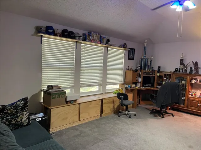 a spacious bedroom with a bed dresser and a window