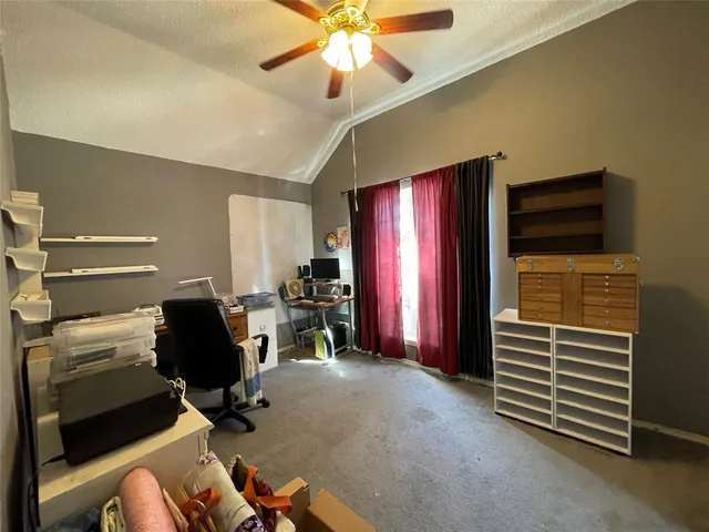 a view of house with outdoor seating and covered with trees