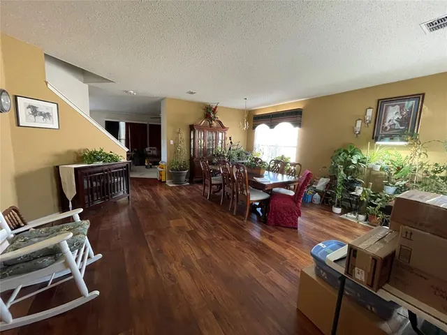 a living room with furniture gym equipment and a flat screen tv