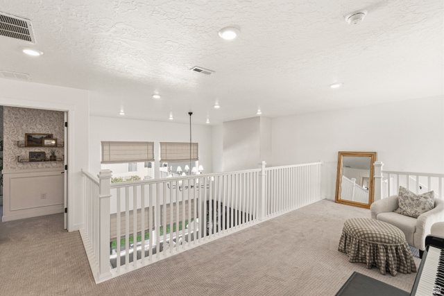 870 North Ada Loop Lehi, UT 84048 - Photo 27 of 51 Upper-level landing featuring light-toned carpeting, white balustrade railing, recessed lighting, and a view to the floor below