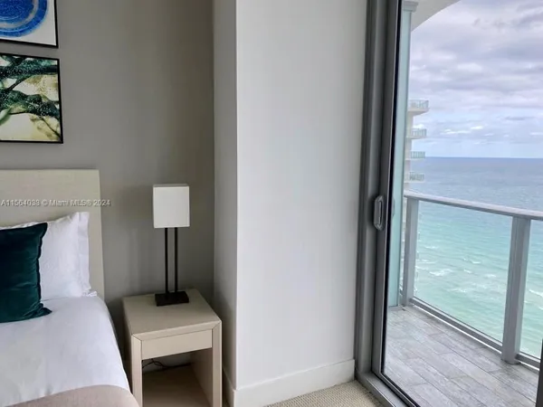 a bedroom with bed and painting on the wall