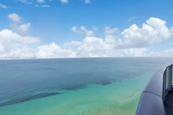 a living room with a table and a potted plant