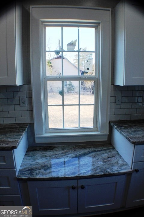 1007 Burch Street Cadwell, GA 31009 - Photo 13 of 25 a kitchen with granite countertop a sink a granite counter tops and a window