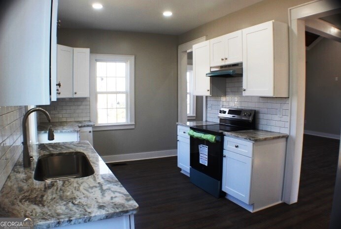 1007 Burch Street Cadwell, GA 31009 - Photo 14 of 25 a kitchen with stainless steel appliances granite countertop a sink stove and cabinets