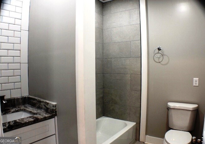 1007 Burch Street Cadwell, GA 31009 - Photo 18 of 25 a bathroom with a granite countertop toilet and a sink