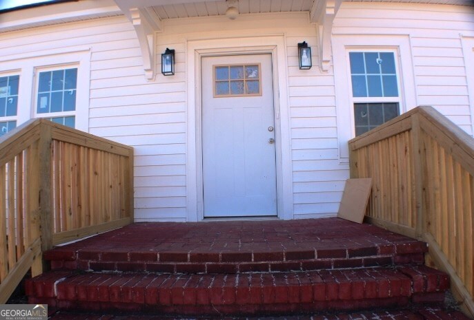 1007 Burch Street Cadwell, GA 31009 - Photo 3 of 25 a view of house with a car parked in front of door