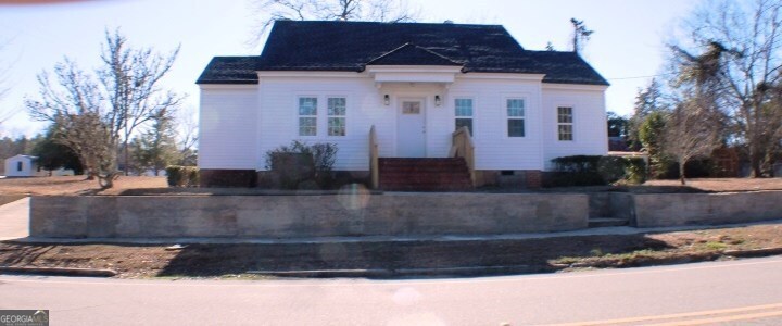 1007 Burch Street Cadwell, GA 31009 - Photo 4 of 25 a front view of a house with a yard