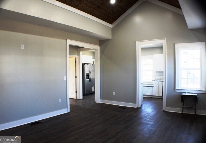 1007 Burch Street Cadwell, GA 31009 - Photo 9 of 25 an empty room with wooden floor and windows