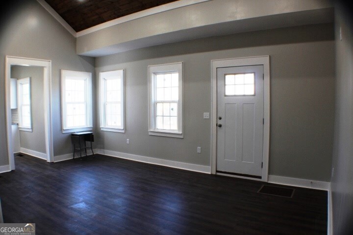 1007 Burch Street Cadwell, GA 31009 - Photo 10 of 25 an empty room with wooden floor and windows